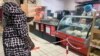 Senegal woman shopper at grocery store - supermarket - food - economy