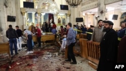 A general view shows people looking at the aftermath following a bomb blast which struck worshipers gathering to celebrate Palm Sunday at a Coptic Church in the Nile Delta City of Tanta, 120 kilometers (75 miles) north of Cairo, April 9, 2017.