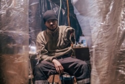An Azov Special Forces Regiment's serviceman injured during fighting against Russian forces poses for a photographer inside the Azovstal steel plant in Mariupol on May 10, 2022. (Dmytro 'Orest' Kozatskyi/Azov Special Forces Regiment of the Ukrainian National Guard Press Office via AP)
