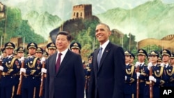 Chinese President Xi Jinping and U.S. President Obama take part in a welcome ceremony at the Great Hall of the People in Beijing in 2014. The pending sanctions might cool relations when Mr. Xi makes his first state visit to the U.S. (AP Photo/Andy Wong)