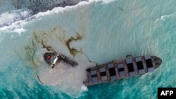 This aerial picture taken on August 16, 2020, shows the MV Wakashio bulk carrier that had run aground and broke into two parts near Blue Bay Marine Park, Mauritius. 