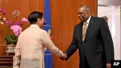 U.S. Secretary of Defense Lloyd James Austin III shake hands with Philippine President Ferdinand Marcos Jr. during a courtesy call at the Malacanang Palace in Manila, Feb. 2, 2023. (Jam Sta Rosa/Pool Photo via AP)