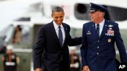 FILE - Michael Minihan, right, now a U.S. Air Force general, walks with President Barack Obama to board Air Force One, at Andrews Air Force Base, Maryland, June 4, 2012.