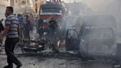 FILE - Syrians gather at the site of an explosion in the northeastern Kurdish city of Qamishli, Oct. 11, 2019.