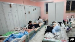 Pregnant women and new born babies in the basement of a maternity hospital converted into a medical ward and used as a bomb shelter during air raid alert in Kyiv, Ukraine, Wednesday, March 2, 2022. Russian forces have escalated their attacks on crowded cities in what Ukraine's leader called a blatant campaign of terror. (AP Photo/Efrem Lukatsky)