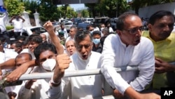Sri Lankan opposition leader Sajith Premadasa, left, along with other opposition lawmakers, shout anti government slogans during a protest in Colombo, Sri Lanka, April 3, 2022.