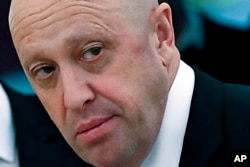 FILE - Russian businessman Yevgeny Prigozhin is shown prior to a meeting of Russian President Vladimir Putin and Chinese President Xi Jinping in the Kremlin in Moscow, Russia, July 4, 2017.