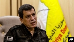 Kurdish commander, Mazloum Abdi, of the U.S.-backed Syrian Democratic Forces, speaks during a news conference in Hassakeh, Syria, Saturday, Nov. 26, 2022. 
