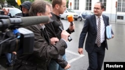 FILE - Belgium Justice Minister Vincent Van Quickenborne, right, at the Prime Minister's Residence in Brussels, July 16, 2012. He said aid worker Olivier Vandecasteele was "innocently arrested in February and has been held under inhumane conditions since."