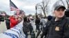 FILE - A U.S. Supreme Court police officer stands on alert in Washington on Jan. 6, 2021.
