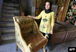 Iraqi carpenter Nour al-Janabi displays a piece at her home furniture workshop in Baghdad's Abu Dsheer area, on Nov. 13, 2022.