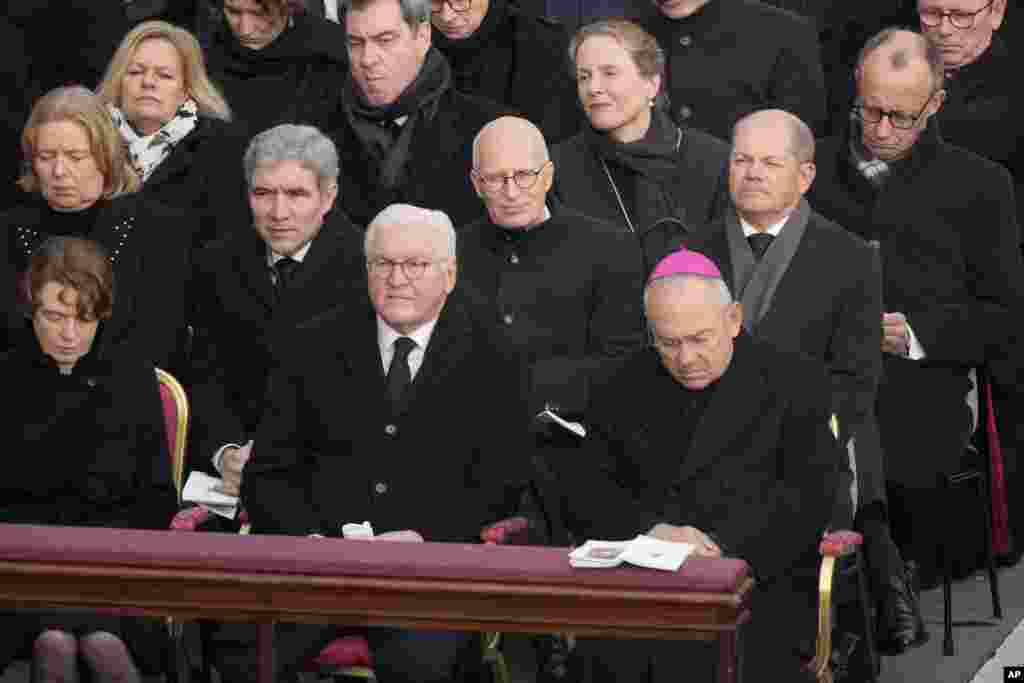German President Frank-Walter Steinmeier, center, and German Chancellor Olaf Scholz, 3rd right, attend the funeral of late Pope Benedict XVI in St. Peter's Square at the Vatican, Jan. 5, 2023.