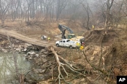 Washington County Road Department constructs an emergency dam to intercept an oil spill after a Keystone pipeline ruptured at Mill Creek in Washington County, Kansas, Dec. 8, 2022.
