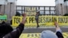 An activist shouts slogans during a protest against Indonesia's potential new criminal code outside the Indonesian Parliament buildings in Jakarta, Indonesia, Dec. 5, 2022. 