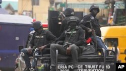 FILE - Police officers patrol during a protest on the street in Lagos, Nigeria, July 26, 2022. Demonstrators took to the streets in Nigeria's central Niger state on Jan. 17, 2023, to protest the killing of a Catholic priest. 