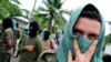 Los miembros del grupo narcotraficante 'Rastrojos' son vistos después de entregar sus armas en una base militar en la provincia de Carepa en Medellín, el 21 de mayo de 2009.