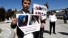 FILE - Uyghur Turks who said they hadn't heard any news about relatives in Eastern Turkistan attend a protest near the Chinese Embassy, in Ankara, Turkey, May 24, 2022. 