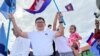 FILE - Vice President of Candlelight Party, Son Chhay, waves flags during a campaign rally for the upcoming local elections on June 5, in Phnom Penh, Cambodia May 21, 2022. Picture taken on May 21, 2022. (REUTERS/Lach Chantha)