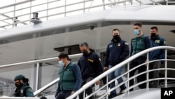  Guards accompany U.S. FBI agents and a U.S.Homeland Security agent from the yacht called Tango in Palma de Mallorca, Spain, Monday April 4, 2022.