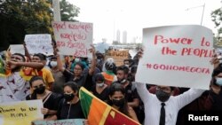 People hold placards as they demand Sri Lanka's President Gotabaya Rajapaksa to resign amid the country's economic crisis, during a protest in Colombo, April 5, 2022.