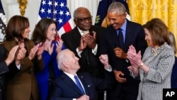 Presidenti Joe Biden shikon nga ish-Presidenti Barack Obama pas nënshkrimit në Shtëpinë e Bardhë të urdhërit ekzekutiv për kujdesin shëndetësor (5 prill 2022)