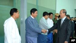 Burma's President Thein Sein, right, is seen off by officials at Rangoon International Airport before heading to Europe for a trip that will include visits to England and France, July 14, 2013, in Rangoon, Burma.