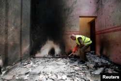 A police officer inspects the site of a gun battle between troops and suspected Islamist militants in Kalmunai, on the east coast of Sri Lanka, April 28, 2019.