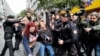 Police officers scuffle with a group of protesters, who attempted to defy a ban and march on Taksim Square to celebrate May Day, in Istanbul, Turkey, May 1, 2022.