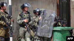Israeli soldiers take positions during clashes with Palestinians in the village of Azzun in the north of the occupied West Bank after the funeral of Yahya Adwan, who was killed during an overnight Israeli army operation, April 30, 2022. 