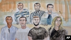In this courtroom sketch by Elisabeth de Pourquery, suspects sit in court on the first day of the Nice attack trial in Paris, Sept. 5, 2022. 