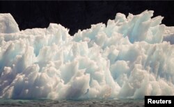 A large iceberg melts into jagged edges as it floats in Eriks Fjord near the town of Narsarsuaq in southern Greenland, July 26, 2009.