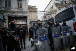 Riot police stand outside the Netherlands consulate as the supporters of Turkey's President Recep Tayyip Erdogan stage a protest in Istanbul, March 11, 2017.