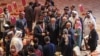 Abdullah Abdullah (C), Chairman of Afghanistan's High Council for National Reconciliation, speaks with members of delegations at the end of the session during the peace talks between the Afghan government and the Taliban in Doha, Sept. 12, 2020.