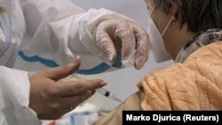 ARHIVA - Medicinska radnica daje ženi vakcinu protiv Kovida 19 kineskog proizvođača Sinofarm, u Beogradu, Srbija, 21. januara 2021. (Foto: Reuters/ Marko Đurica)
