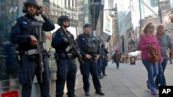FILE - Officers from the New York Police Department's anti-terror unit patrol Times Square, Nov. 4, 2016.