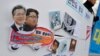 Pictures of South Korean President Moon Jae-in and North Korean leader Kim Jong Un are seen on a sign during a rally to denounce the U.S. policy against North Korea in Seoul, South Korea, Jan. 16, 2018
