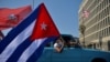 Cubans drive past the US embassy during a rally calling for the end of the US blockade against Cuba, in Havana, March 28, 2021 
