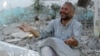 A man cries in front of houses destroyed during a recent Syrian Air Force air strike in Azaz, about 47 kilometers north of Aleppo, Syria, August 15, 2012.