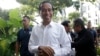 Incumbent Indonesian President Joko Widodo, center, smiles upon arriving for a meeting with leaders of his coalition parties in Jakarta, Indonesia, April 18, 2019.