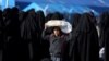 A boy carries bread on his head at al-Hol displacement camp in Syria, April 2, 2019.