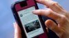 FILE - A mobile phone is used to access news from The Huffington Post on Facebook, in Los Angeles, April 28, 2015.