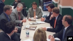 FILE - Lobbyist Brian Ballard, center meets with other lobbyists, from center to left, Mac Stipanovich, Gene McGee Joe McCann, Courtney Bense, Greg Turbeville, Matt Bryan, and Clark Smith in the Capitol cafeteria before the legislative session begins, April 15, 2014, in in Tallahassee, Florida.