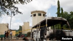 A burnt vehicle stands in front of the entrance of the medium-security prison after the attack by several gunmen in Kuje, near Abuja, Nigeria July 6, 2022.