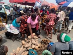 FILE - People shop at a fresh food market in Oyingbo, Lagos, Nigeria, Dec. 17, 2021.