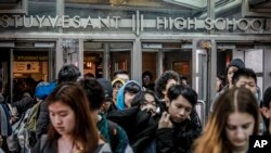 FILE - Students at Stuyvesant High School leave after classes end for the week, March 13, 2020, in New York.