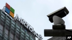 FILE - A security camera is seen near a Microsoft office building in Beijing, China, July 20, 2021. State-backed Russian hackers have engaged in “strategic espionage” against governments, think tanks, businesses and aid groups in 42 countries backing Ukra