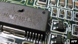 FILE - A key property of today’s computer chips is the distance electrons must travel from one transistor to the next. Thinner transistors means speedier travel for those electrons. 