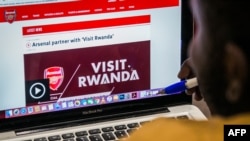 An Arsenal fan looks at the website of England's Arsenal football Club that shows Rwanda's new tourism promotion logo in Kigali on May 23, 2018.