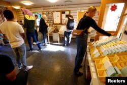 People pick ballot papers at a polling station during a general election in Stockholm, Sweden, Sept. 9, 2018.