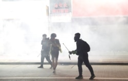 Anti-government protesters react as police fire tear gas during a demonstration, in Hong Kong, Nov. 2, 2019.